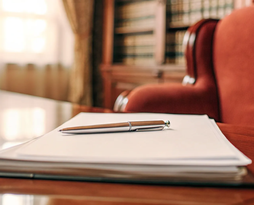 A non-compete agreement on a lawyer's desk with a pen for review.