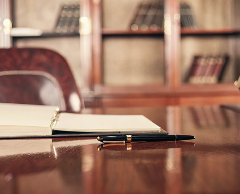 Breach of contract lawyer free consultation with justice scales and a legal binder on a desk.