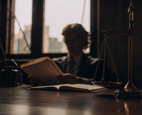 Business fraud attorney analyzing evidence with scales of justice on the desk.