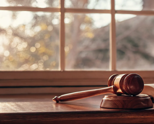 A law book and gavel on a desk, outlining the grounds for contesting a will in Florida.