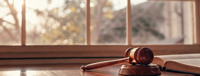 A law book and gavel on a desk, outlining the grounds for contesting a will in Florida.