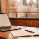 An attorney's desk with law books and a laptop for handling landlord issues.