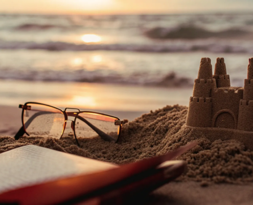 A book and eyeglasses on a beach, explaining the steps on how to contest a will.