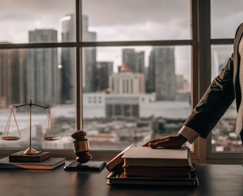 Real estate litigation attorney reviews a case file with a gavel and scales of justice on the desk.