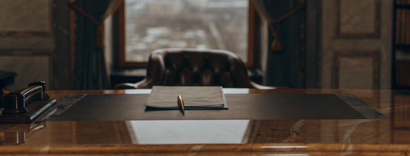 A pen on a contract highlights the cost of a real estate attorney for closing.