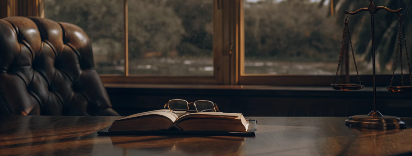 A law book and scales of justice on a desk explaining why you would need a probate attorney.