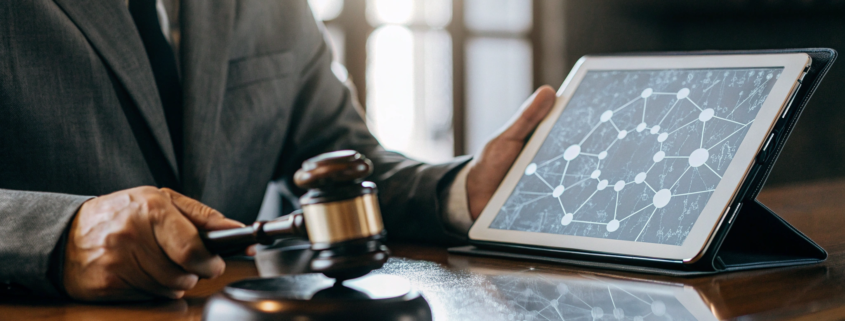 A lawyer with a gavel reviews the legal steps to sue someone for scamming you online.