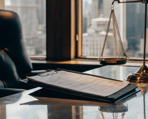 Legal documents and scales of justice on the desk of a commercial litigation attorney.