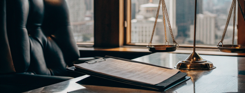 Legal documents and scales of justice on the desk of a commercial litigation attorney.
