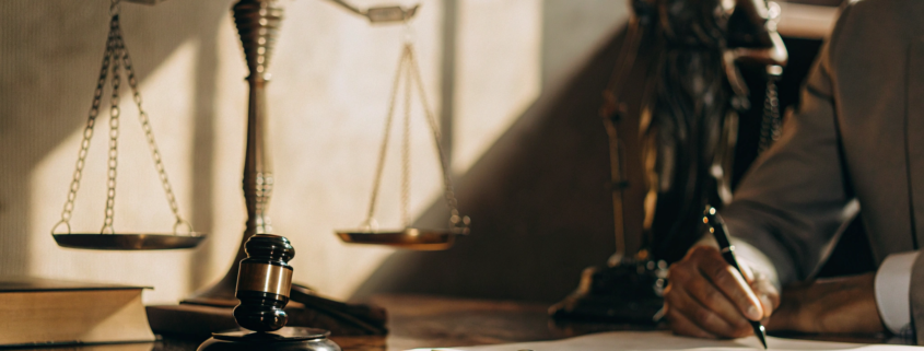 Scales of justice and a gavel on a desk, showing the legal factors in the success rate of contesting a will.
