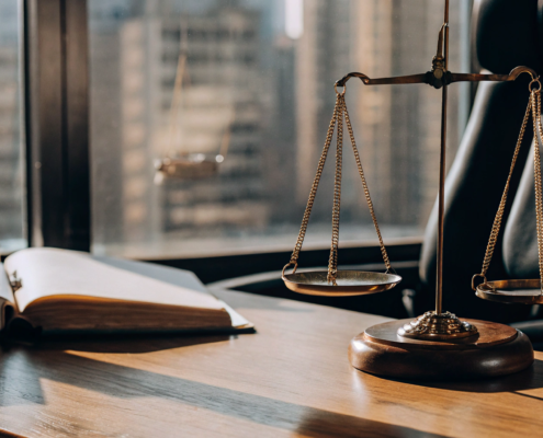 A real estate lawyer's desk with scales of justice for an eviction case.