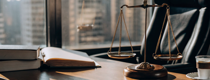 A real estate lawyer's desk with scales of justice for an eviction case.