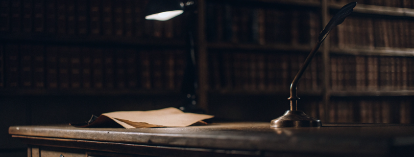 A formal warning letter of partition action with a quill pen on a desk.