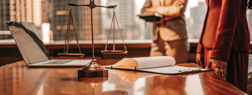 A commercial real estate litigation attorney reviews a case with legal documents and scales of justice.