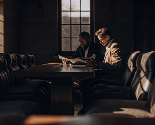 A joint venture dispute attorney advises partners while reviewing their business agreement.