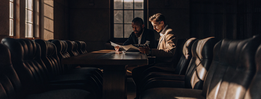 A joint venture dispute attorney advises partners while reviewing their business agreement.