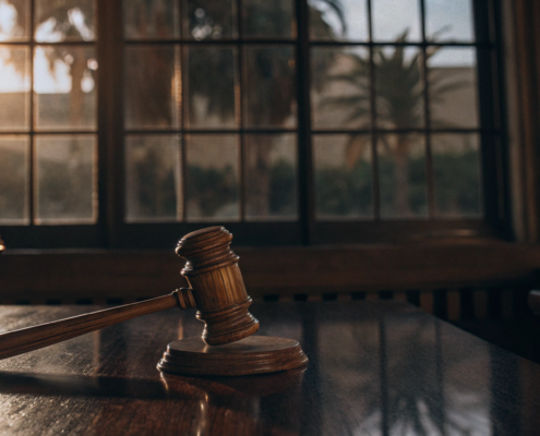 Gavel and scales of justice on a desk, representing where to file a complaint against a landlord.