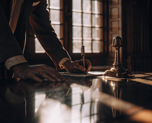 A buyer or seller signing closing documents with the real estate attorney they hired.