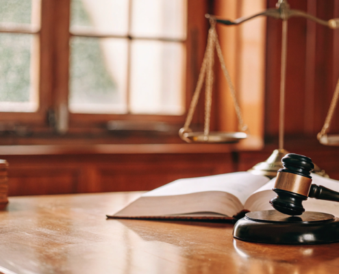 Scales of justice and a gavel for a breach of fiduciary duty attorney.
