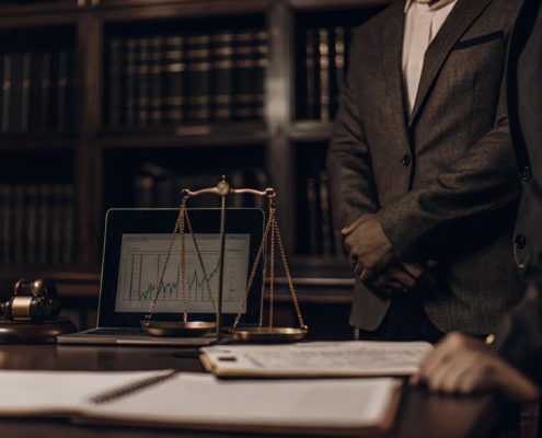 A person reviewing the real estate commission lawsuit settlement website on a laptop with claim documents.